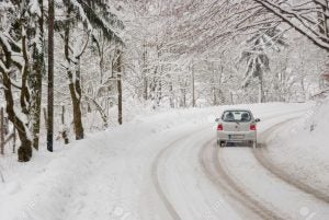 9948437-driving-with-bad-weather-conditions-road-is-covered-by-snow-stock-photo